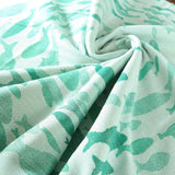 Swirling Fishes Emerald Half linen Blanket by Didymos